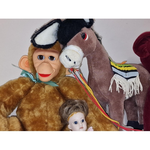 104 - Group of vintage soft toys to include Merrythought Donkey together with two bisque dolls one of whic... 