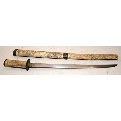 130 - A vintage Japanese short sword with carved bone scabbard and handle. O/all length 63cms