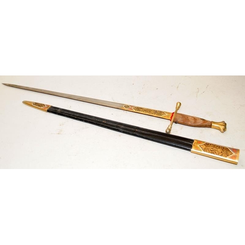 158 - Decorative sword with brass crosspiece and wooden handle c/w leather and brass scabbard