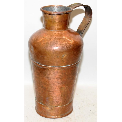 451 - Large antique copper jug with riveted handle and planished finish. 38cms tall