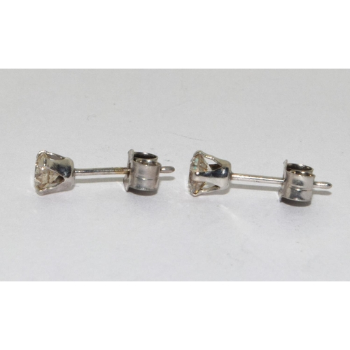 279 - A pair of 14ct W/G diamond stud earrings.