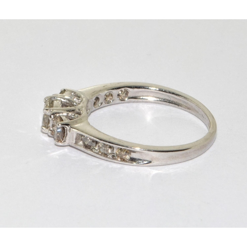 353 - A White  Gold  three stone diamond ring. Size N