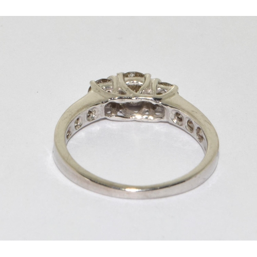 353 - A White  Gold  three stone diamond ring. Size N