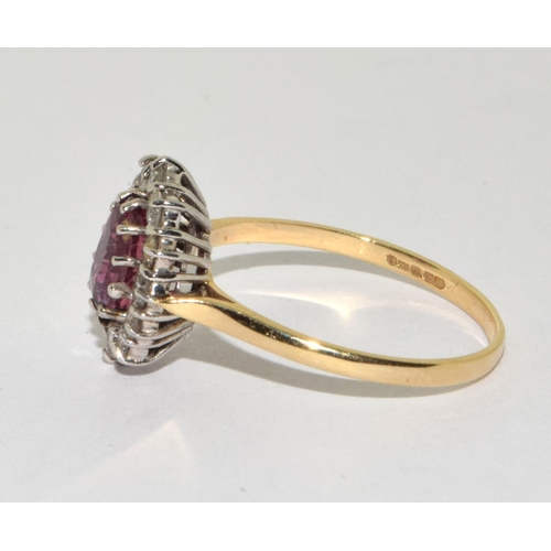 388 - An 18ct Y/G ring the central spinel surrounded bu diamonds. Size S