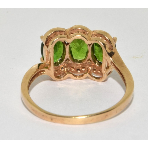 380 - A Y/G tourmaline and diamond ring. Size P