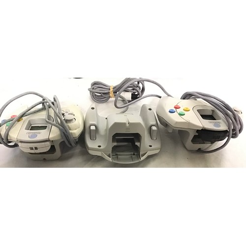 444 - SEGA DREAMCAST CONTROLLERS. A total of 3 hand held devices here with a collection of Rf converter ca... 