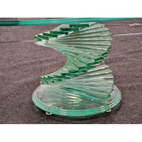 539 - Contemporary glass oval coffee table on stepped twisted glass base 42x120x70cm.