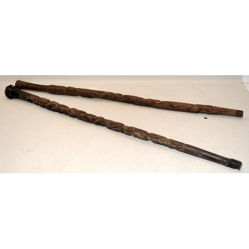 405 - Two early African carved hardwood walking canes, each around 85cms long