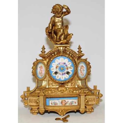 355 - Antique French ormolu striking mantel clock featuring hand painted porcelain panels with a cherub fi... 