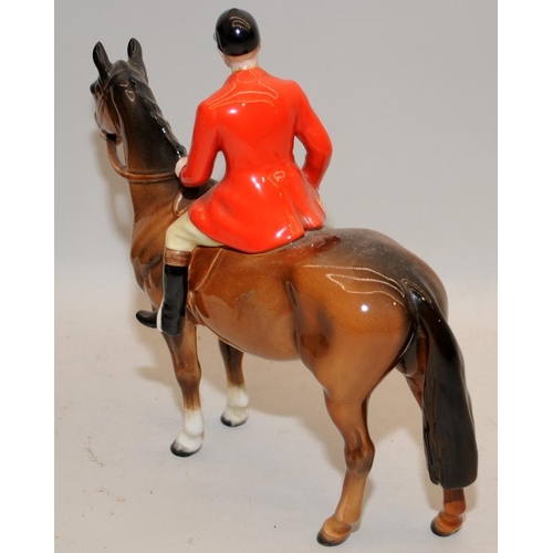 105 - Vintage Beswick Huntsman figure on a horse. 22cms tall