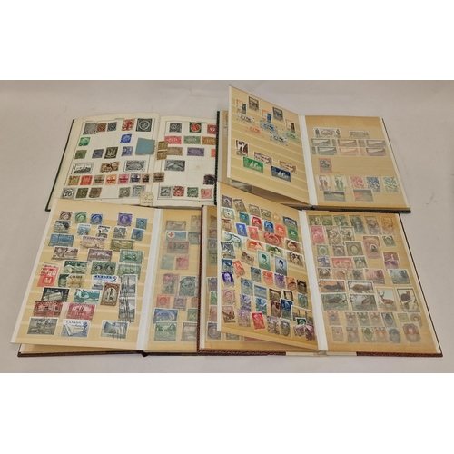 57 - Four small stamp stock books containing worldwide stamps.