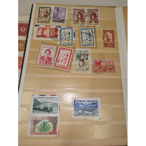 57 - Four small stamp stock books containing worldwide stamps.