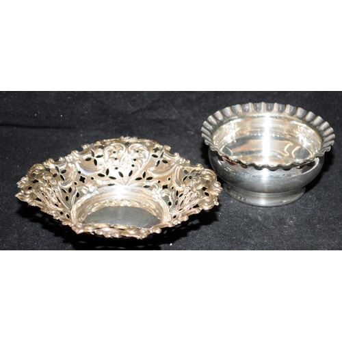 150 - A collection of silver plated items including wine coasters, bon bon dishes and a candle nightstick