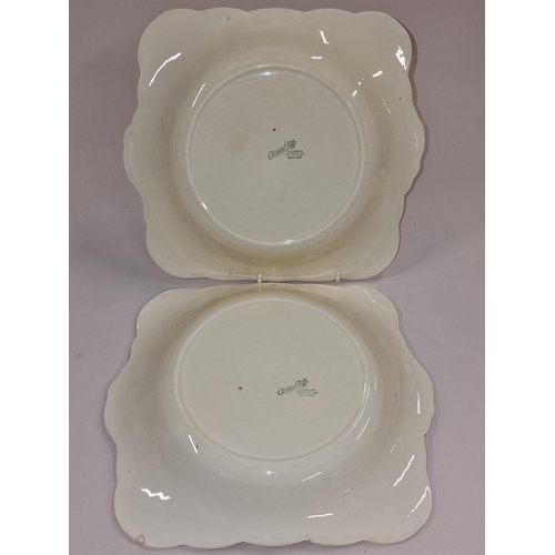 119 - Pair of Clarice Cliff sandwich plates together with two vases (4).