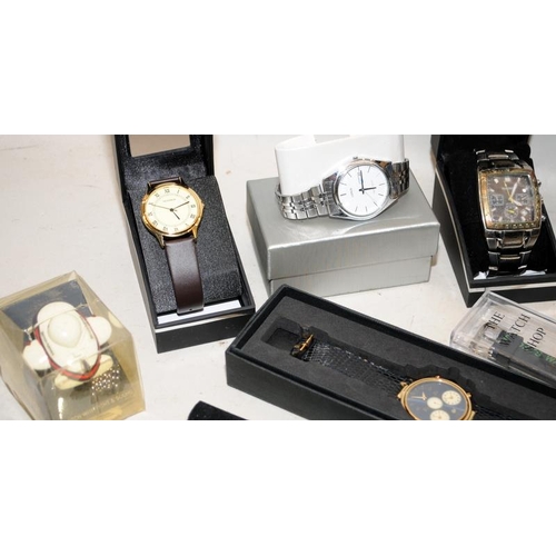 243 - A collection of gents fashion watches requiring new batteries. Mostly boxed