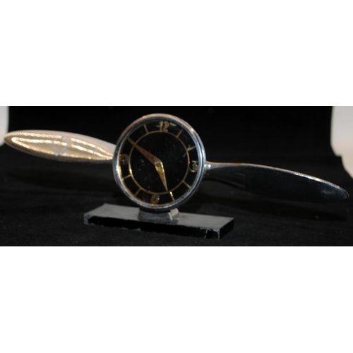 247 - Two vintage desk clocks, an Art Deco chrome example in the form of a propeller and another in the fo... 