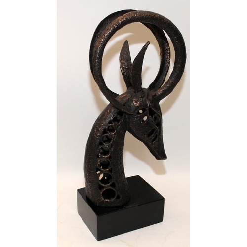 289 - Modernist cast metal sculpture of a horned animal's head. 37cms tall including plinth