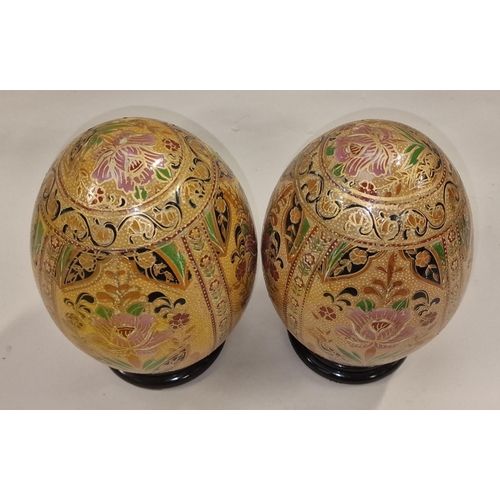 358 - Pair of porcelain eggs on wood stands