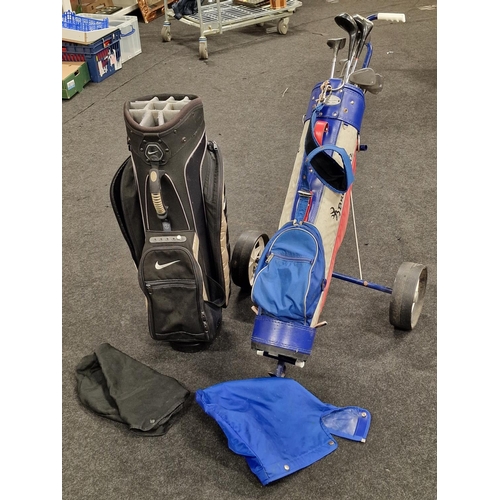 436 - A Nike golf club bag together with a vintage set of golf clubs in a Browning bag and a golf trolley.... 