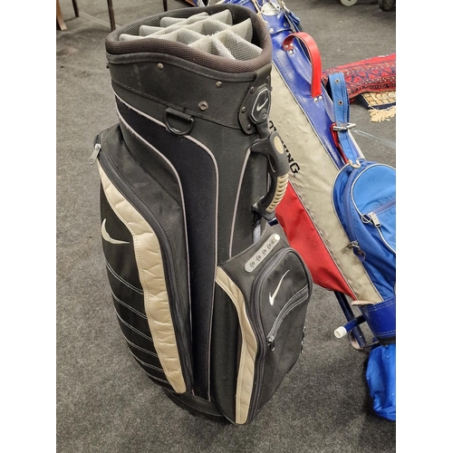 436 - A Nike golf club bag together with a vintage set of golf clubs in a Browning bag and a golf trolley.... 