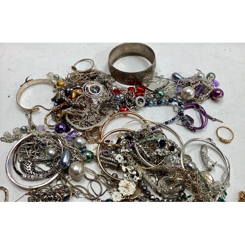 303 - Bag of costume Jewellery