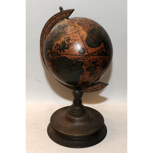 34 - Reproduction of an antique terrestrial globe on wooden stand. 28cms tall