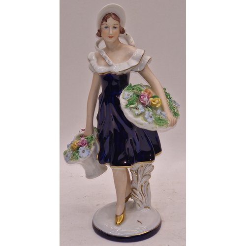 32 - Royal Dux porcelain figurine of a girl holding flowers. 27cm tall. In good overall condition.
