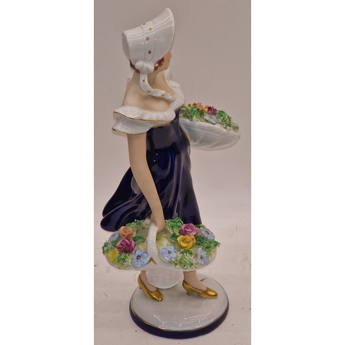 32 - Royal Dux porcelain figurine of a girl holding flowers. 27cm tall. In good overall condition.