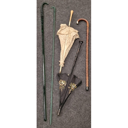 176 - Two vintage glass walking sticks together with another walking stick and two brolly's (5)