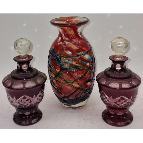 38 - Pair of Bohemian vintage ruby red bottles with toppers together with a Mdina coloured glass vase (3)... 