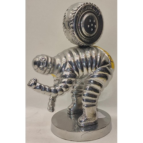 55 - Silver metal Michellin Man carrying a tyre 30cm tall.