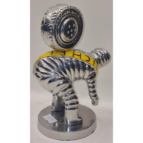 55 - Silver metal Michellin Man carrying a tyre 30cm tall.