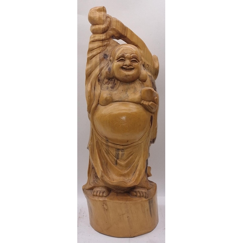 78 - A large wooden Buddha 65cm tall.