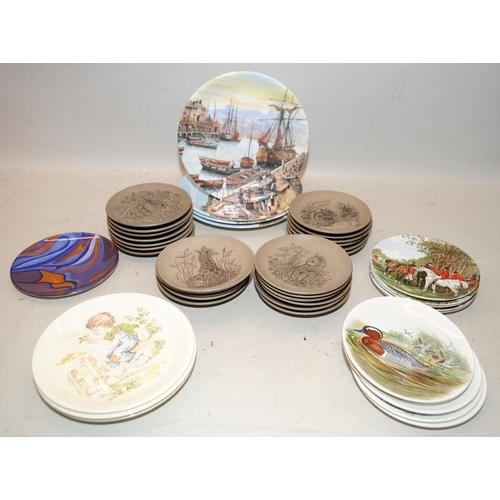 56 - A large collection of Poole Pottery plates including stoneware examples
