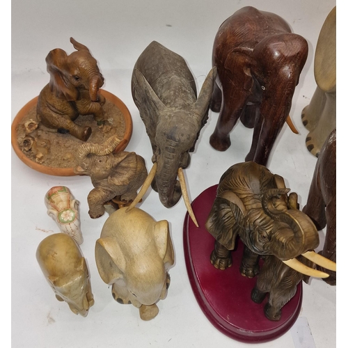 119 - Collection of various elephant figurines mainly of wood construction.