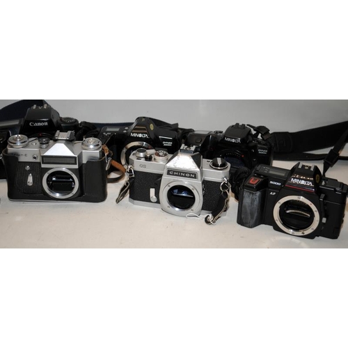 57 - A collection of vintage 35mm film SLR cameras to include Minolta, Canon Zenit etc. 11 in lot