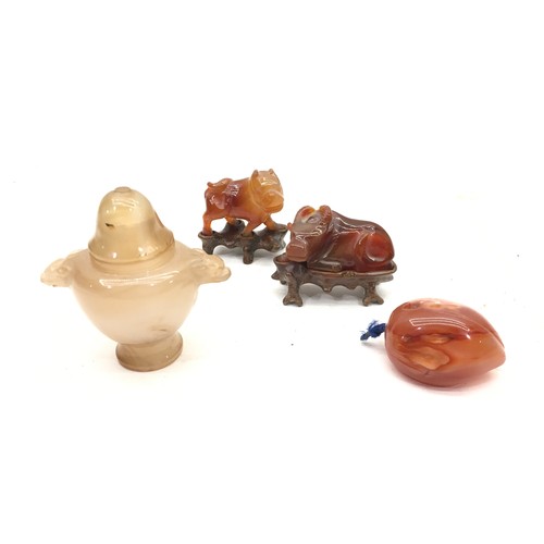 65 - Four pieces of Chinese agate and stands.