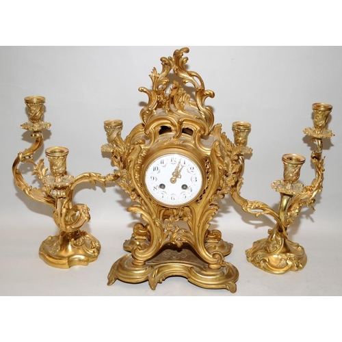 145 - A reproduction brass Art Nouveau style mantel clock and three branch candlesticks garniture, decorat... 