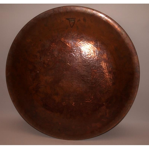 52 - Large Eastern copper charger with extensive applied silver decoration. 51.5cms across