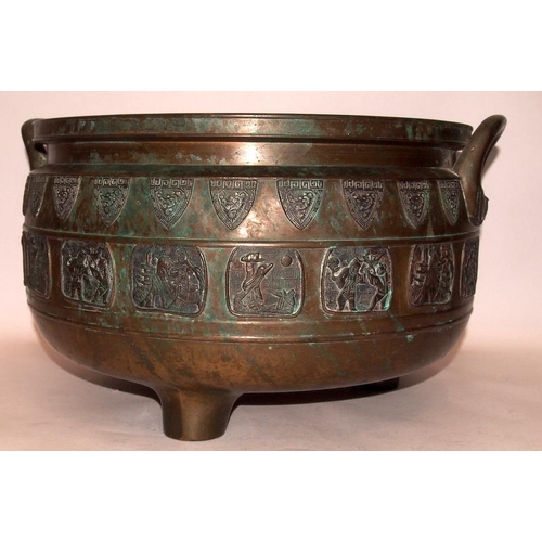 25 - A large bronze twin handled incense burner with exterior decoration of dragon shields and various Or... 