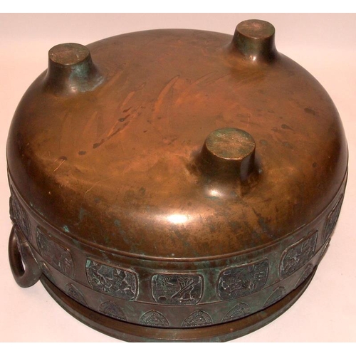 25 - A large bronze twin handled incense burner with exterior decoration of dragon shields and various Or... 