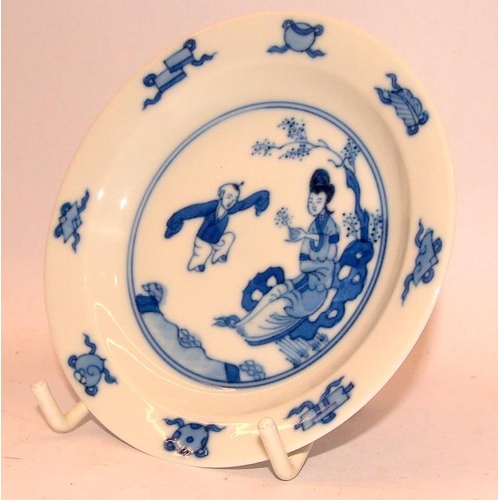 40A - !9th Century or later Oriental blue and white cup and saucer depicting a mother with child and addit... 