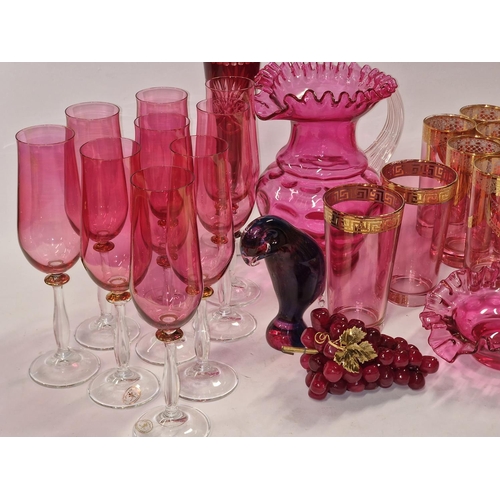 84 - A selection of coloured glass to include glasses, jug and grapes etc.