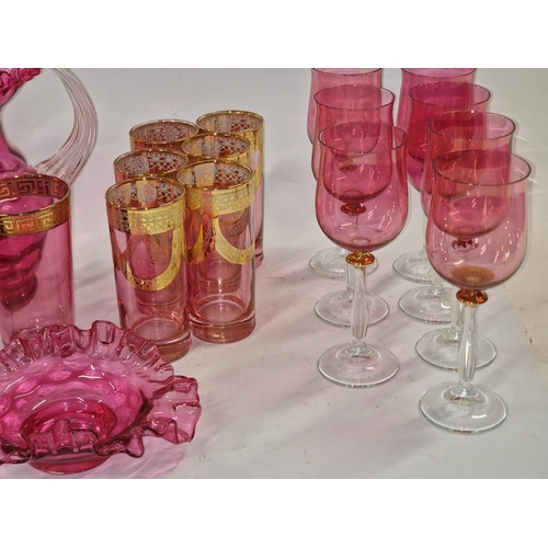 84 - A selection of coloured glass to include glasses, jug and grapes etc.