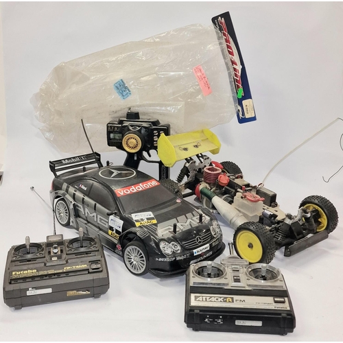 204 - Two radio controlled cars together with three controllers and spares. not tested