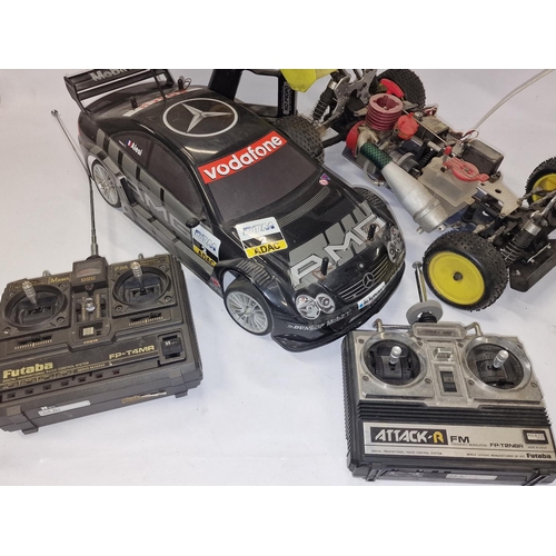 204 - Two radio controlled cars together with three controllers and spares. not tested