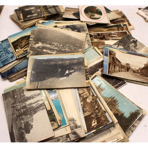 185 - A large collection of vintage postcards including early real photograph examples