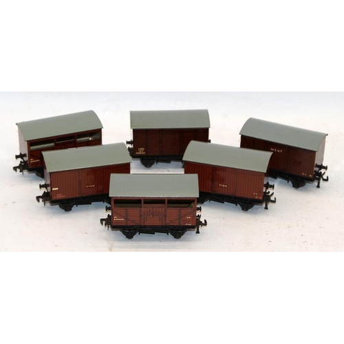 228 - A collection of vintage tinplate OO gauge rolling stock comprising goods wagons and carriages. 20 it... 