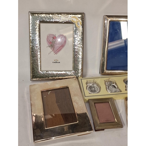 352 - Mixed size collection of silver plate photo frames and a clock