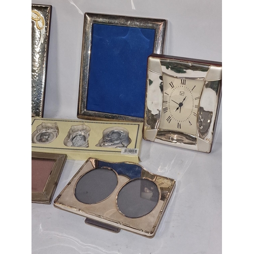 352 - Mixed size collection of silver plate photo frames and a clock